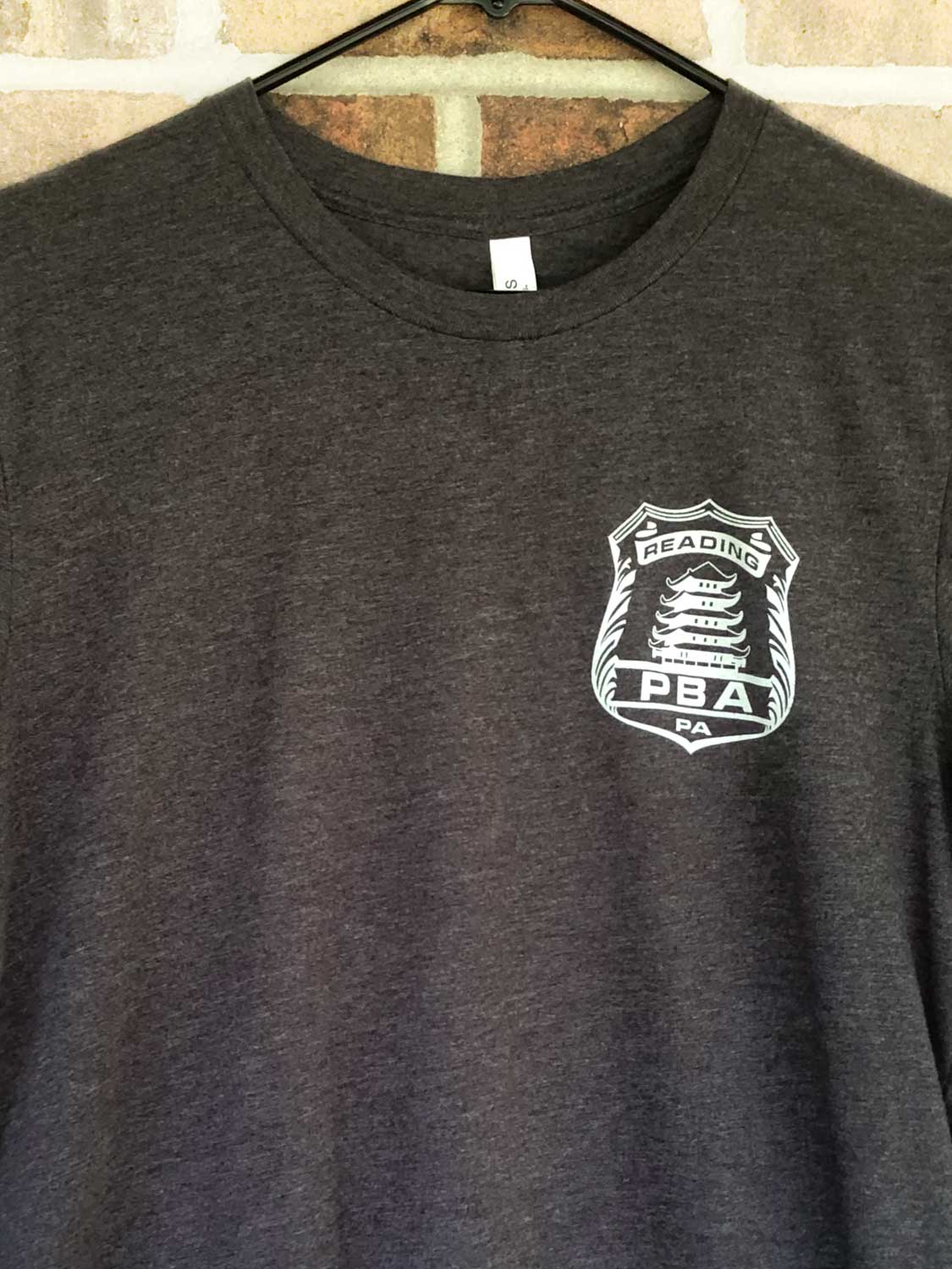 Close up of front of RPBA Gray badge T-shirt